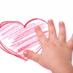 The children's hand is located in heart drawing